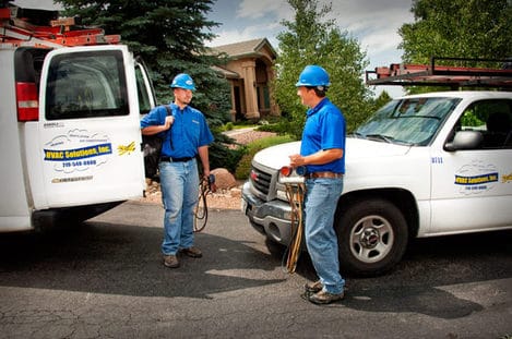 HVAC technician servicing residential furnace in Colorado Springs